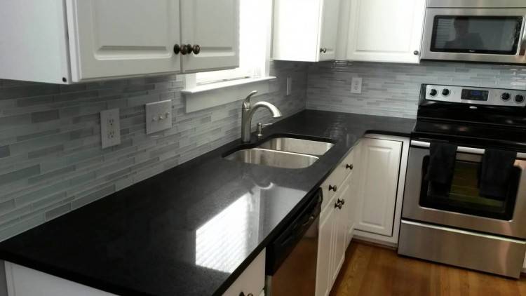 black cabinets white marble countertops kitchen