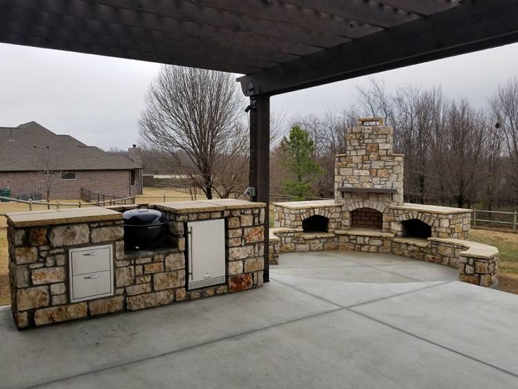 A simple pergola structure covered in vine offers ample shade for the outdoor living area [