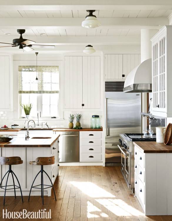 Off white cabinets in casual kitchen by Kitchen Craft Cabinetry