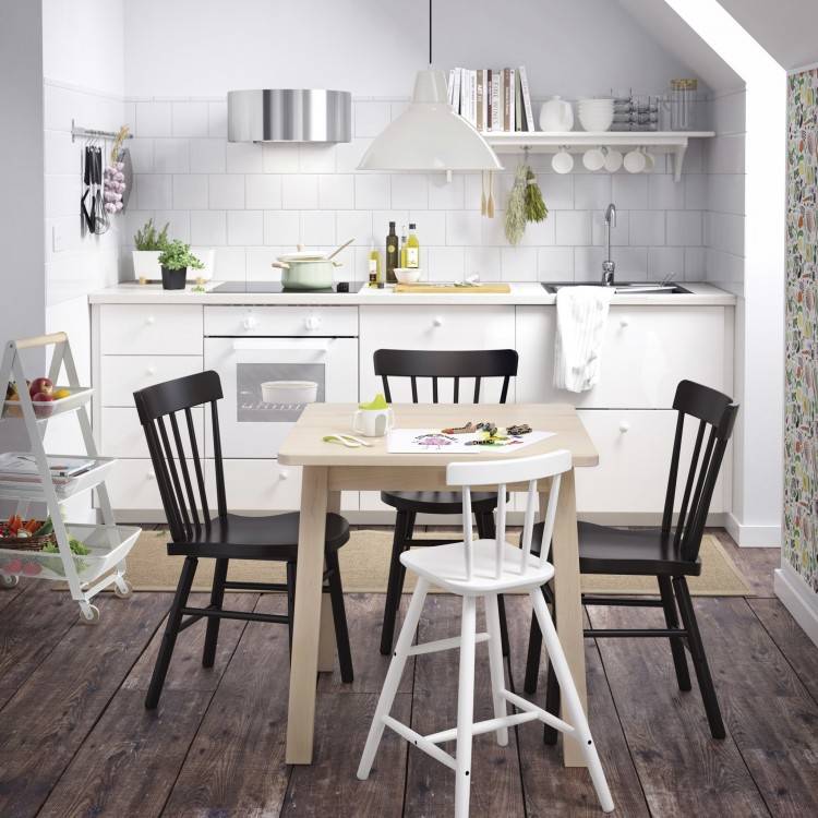 table against the wall, two chairs, one bench seat