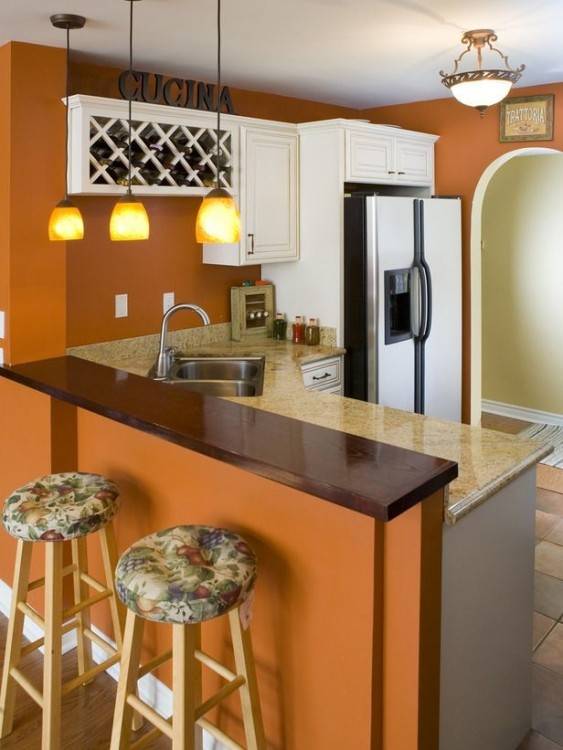 Beautiful use of orange tile as a counter top backsplash in the kitchen