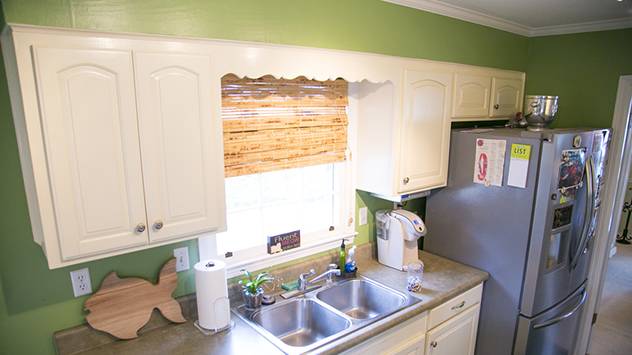 Oak cabinets go all the way to the top of the nine foot ceiling