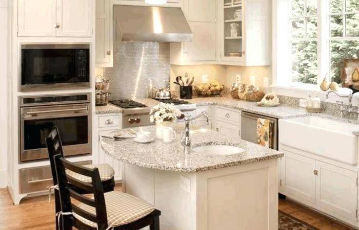 Narrow kitchen in white with a gorgeous island at its heart [Design: Tran +