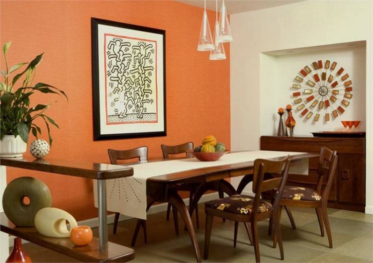 Southwestern orange dining room with chandelier and highback chair