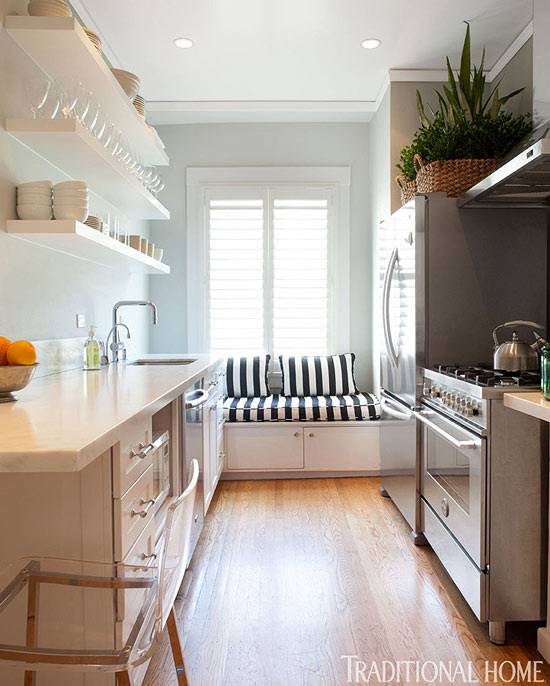 Narrow kitchen in white with a gorgeous island at its heart [Design: Tran +