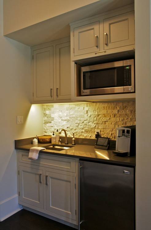 This coffee bar/kitchenette sits in a Master Bedroom for early morning  coffee making or late night snacks! The painted maple cabinets are inset  and feature