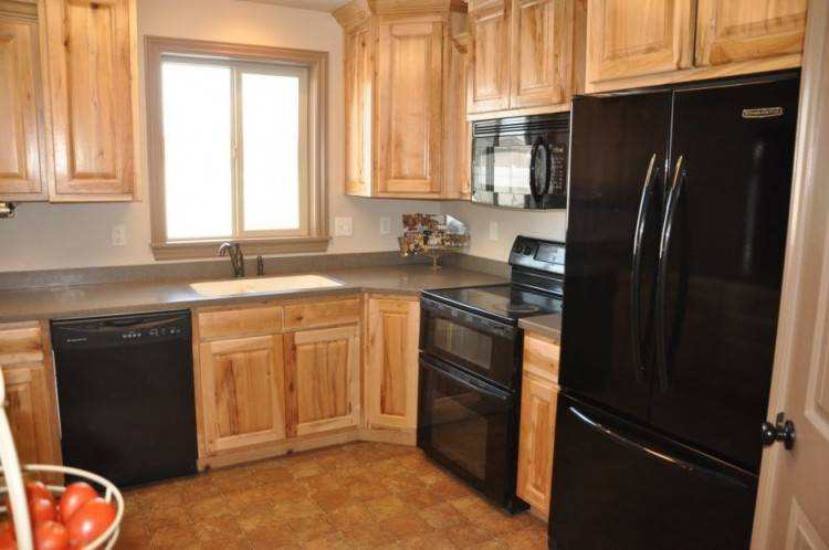 kitchen with white cabinets and black appliances