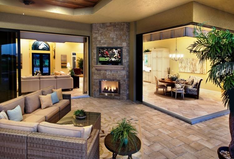 in a living room as outside under a barbecue area? The fireplace flanked by open views on either side will provide warmth to guests snuggling around it,