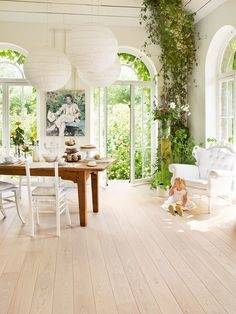 Transitional master bedroom with chandelier, hardwood floor wiith rug, and white bed