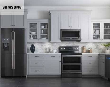 Kitchen with dark cabinets and stainless steel appliances