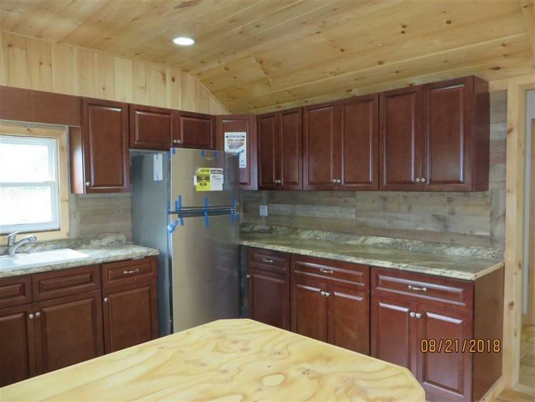 A hanging pot and pan rack and kitchen island create even more prep and practical storage space in the kitchen and can also be removed to open up the area