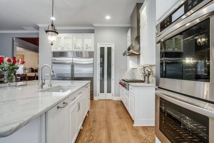 I like the transitional cabinet design, and interesting use of white  lowers, beige uppers with great framing of the white