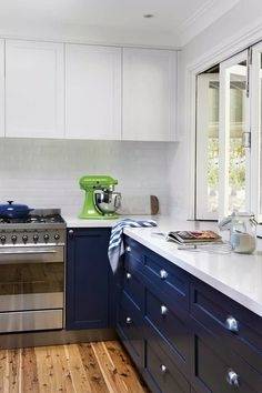 Minimalist all white modern kitchen with smooth surface cabinetry