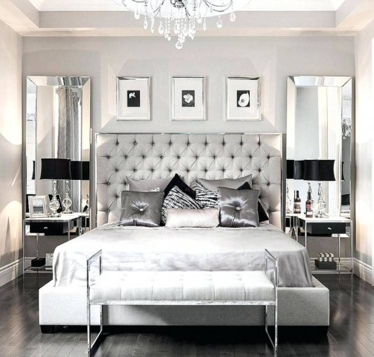 A bedroom in shades of grey and brown, with warm lighting
