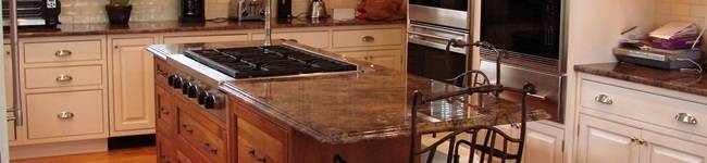 Hershing dark Cherry cabinets with a large white kitchen island