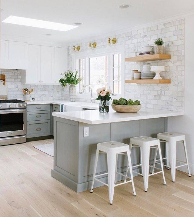 Kitchen with a backsplash featuring patterned white subway tile