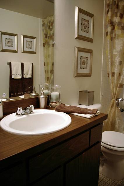 This quaint bathroom has small wooden stools in the shower for extra storage space