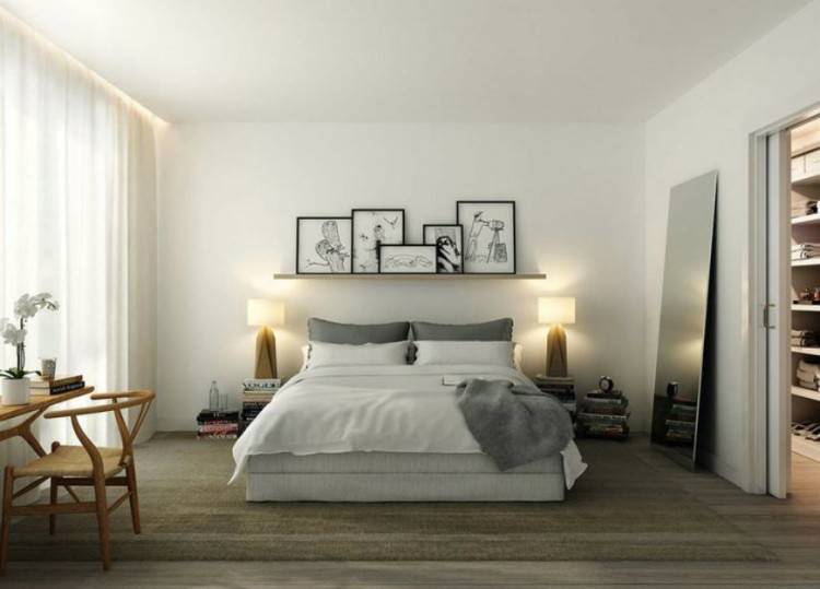 Scandinavian master bedroom with hardwood floor and accent chair